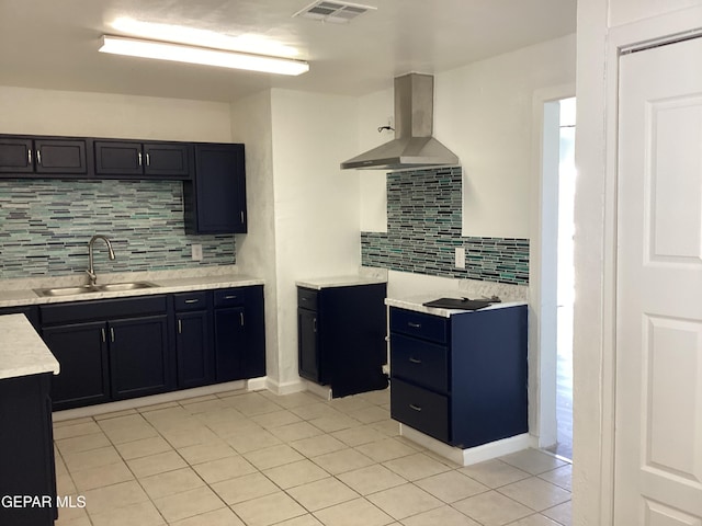 kitchen with sink, backsplash, island range hood, and light tile patterned floors