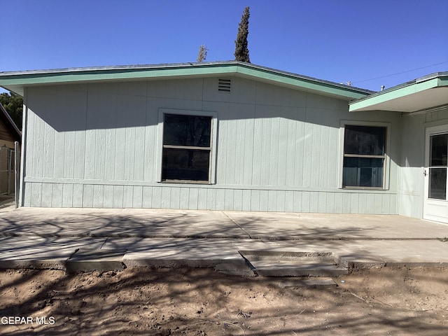 view of property exterior with a patio