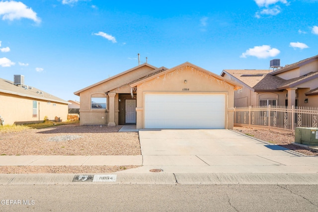 ranch-style home with central air condition unit and a garage