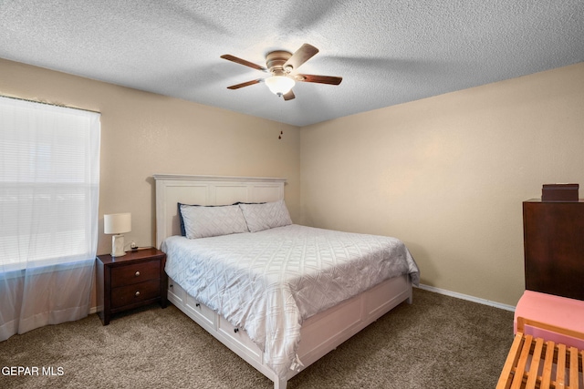 bedroom with carpet, ceiling fan, and a textured ceiling