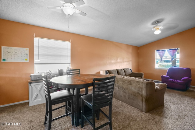 carpeted dining room featuring ceiling fan, vaulted ceiling, and a textured ceiling