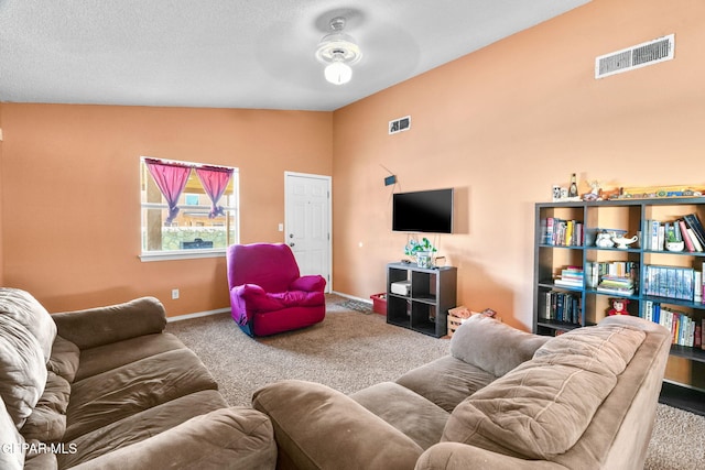 carpeted living room with ceiling fan and vaulted ceiling