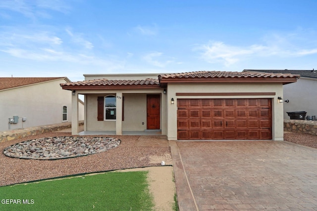 mediterranean / spanish house featuring covered porch and a garage