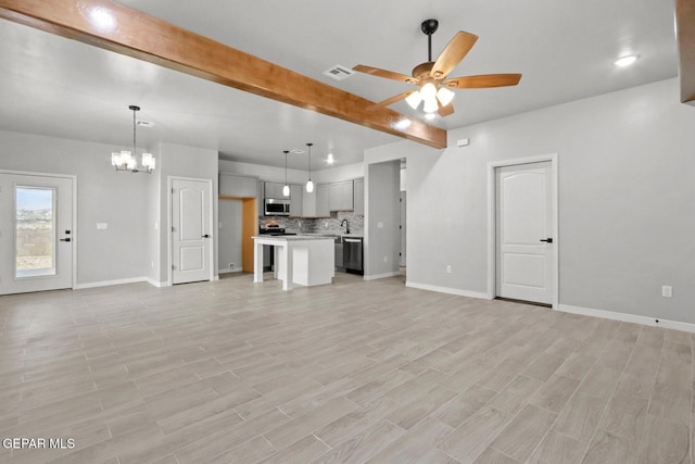 unfurnished living room with ceiling fan with notable chandelier, sink, beam ceiling, and light hardwood / wood-style floors