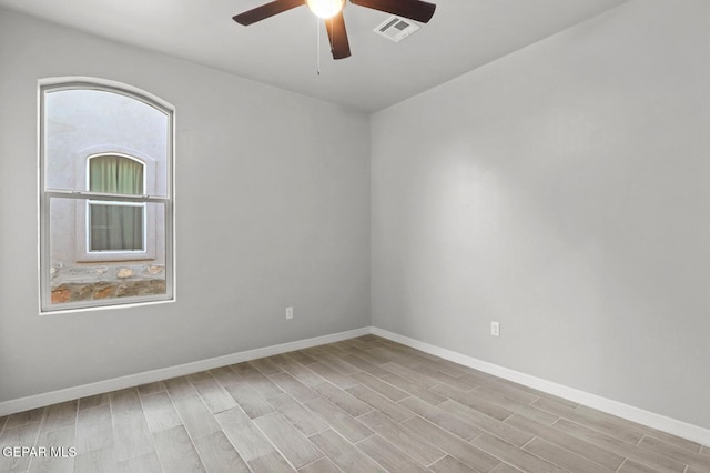 empty room featuring ceiling fan and light hardwood / wood-style flooring