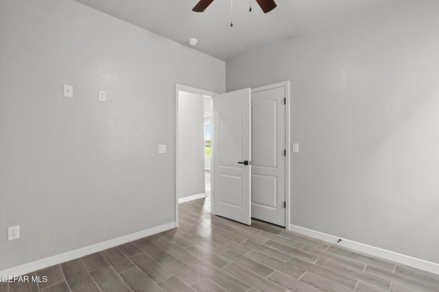 spare room with ceiling fan and light wood-type flooring