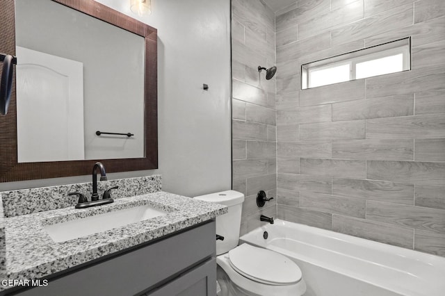 full bathroom featuring toilet, tiled shower / bath combo, and vanity