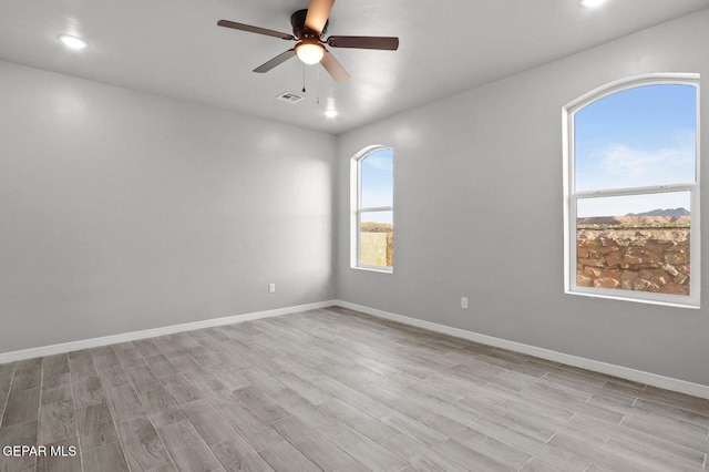 unfurnished room featuring ceiling fan and light hardwood / wood-style flooring