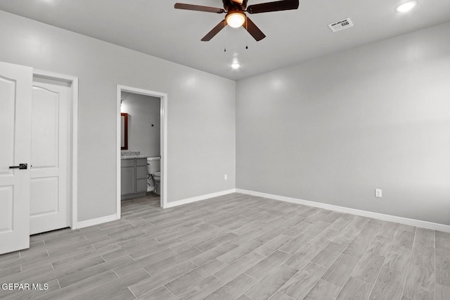 unfurnished bedroom with ensuite bath, ceiling fan, and light wood-type flooring