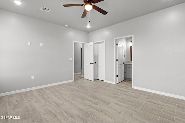 unfurnished bedroom featuring ceiling fan, light hardwood / wood-style floors, and connected bathroom