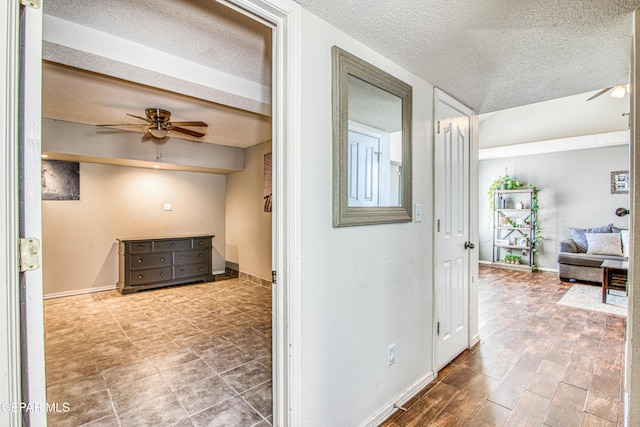 hall with a textured ceiling