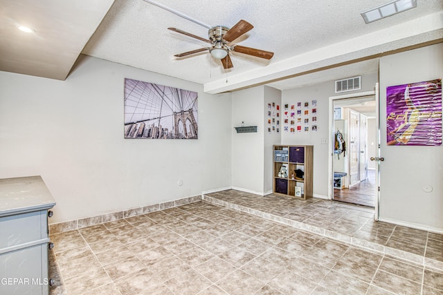 interior space featuring a textured ceiling and ceiling fan