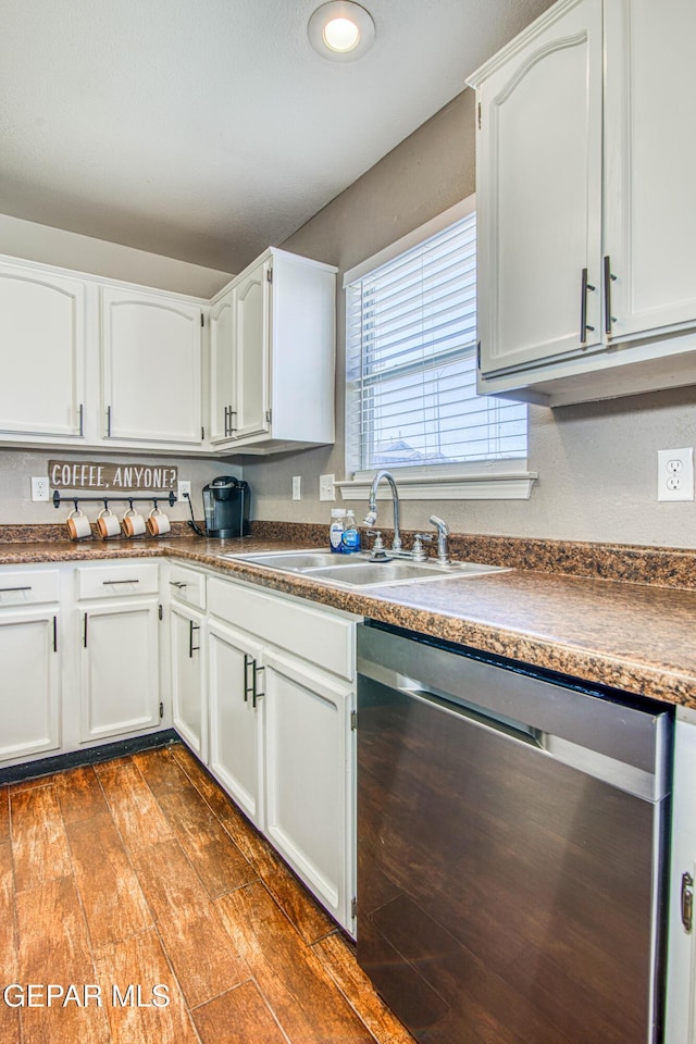 kitchen featuring white cabinets, dishwasher, sink, and hardwood / wood-style floors