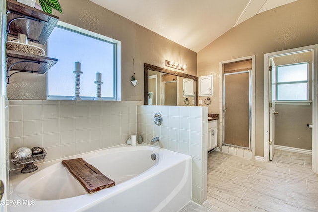 bathroom featuring lofted ceiling, vanity, and plus walk in shower