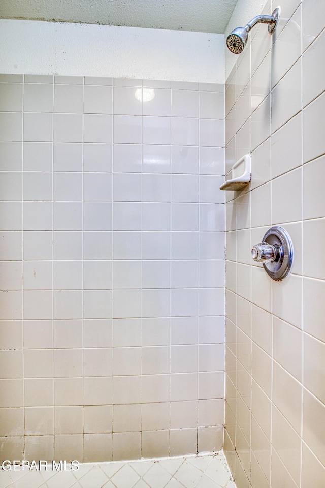 bathroom with tiled shower