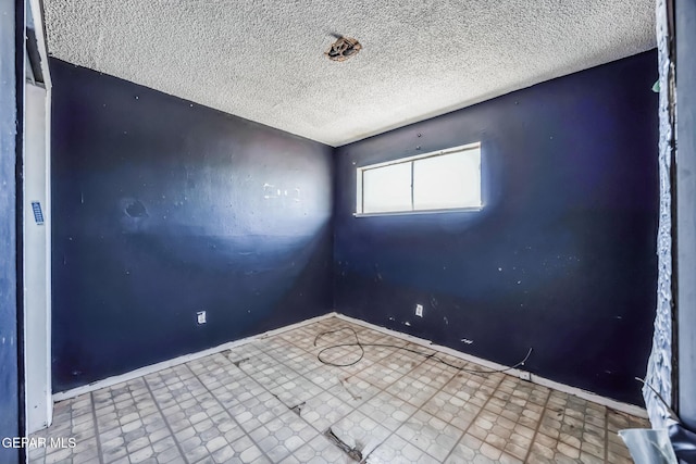 empty room with a textured ceiling