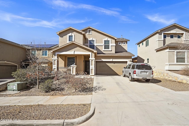 view of front of property featuring a garage, a porch, and solar panels