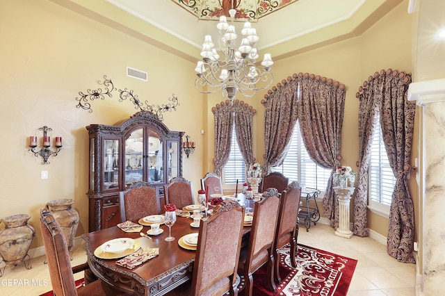 tiled dining space with a high ceiling and a notable chandelier