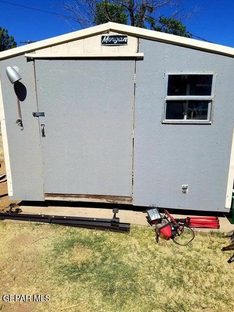 view of property exterior with a shed