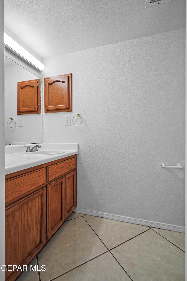 bathroom with tile patterned floors and vanity