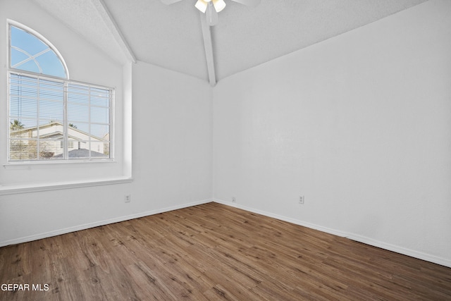 empty room featuring ceiling fan, wood-type flooring, lofted ceiling with beams, and a textured ceiling