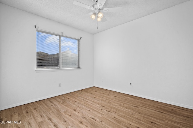 spare room featuring light hardwood / wood-style floors, a textured ceiling, and ceiling fan