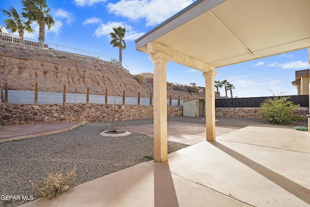 view of yard featuring a patio area and a storage shed