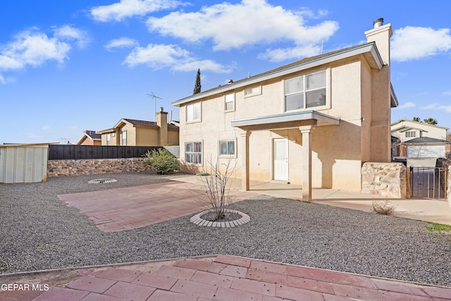 back of house with a patio