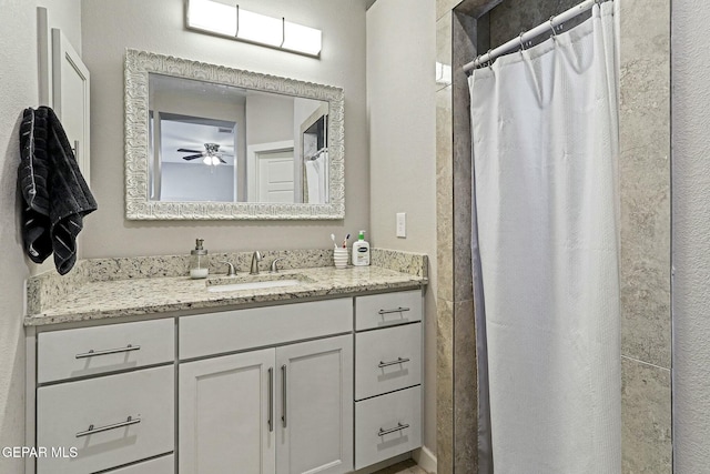 bathroom featuring walk in shower and vanity