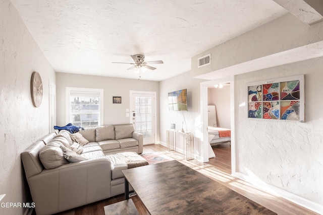 living room featuring hardwood / wood-style floors and ceiling fan