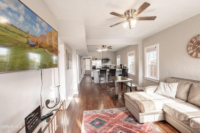 living room featuring hardwood / wood-style flooring and ceiling fan