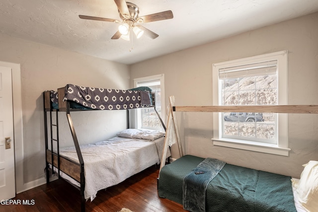 bedroom with ceiling fan and dark hardwood / wood-style flooring