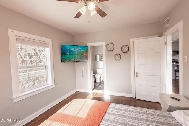 bedroom with dark hardwood / wood-style floors, connected bathroom, and ceiling fan