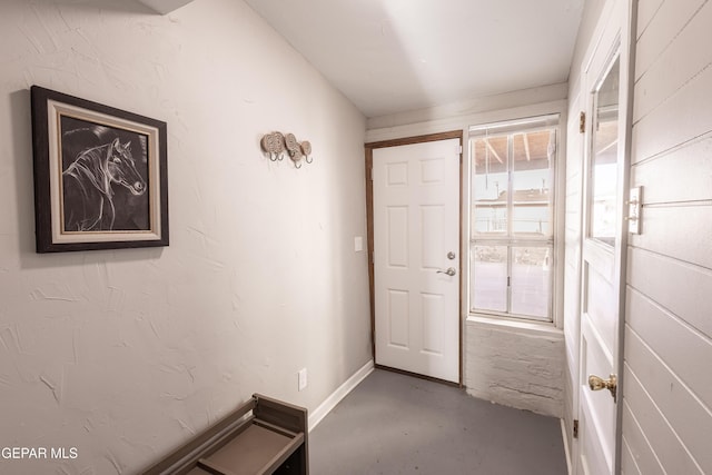 doorway to outside with concrete flooring