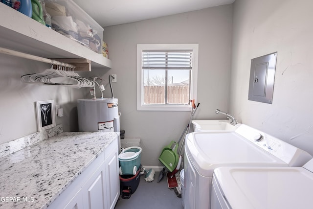 clothes washing area with sink, electric panel, washing machine and clothes dryer, cabinets, and electric water heater