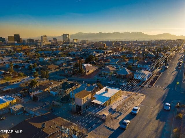 aerial view at dusk featuring a mountain view