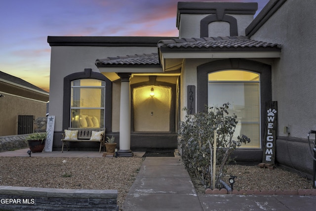 view of exterior entry at dusk