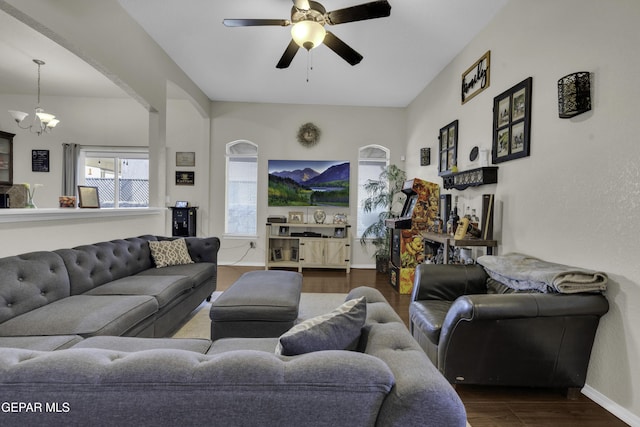 living room featuring hardwood / wood-style floors and ceiling fan with notable chandelier