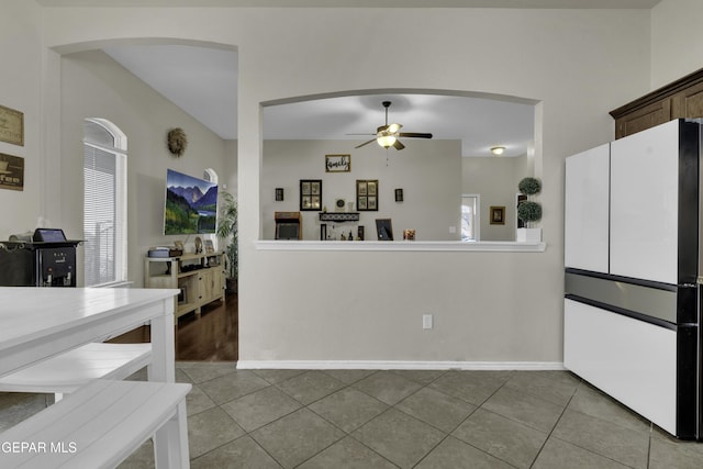 kitchen with ceiling fan, white fridge, and light tile patterned floors