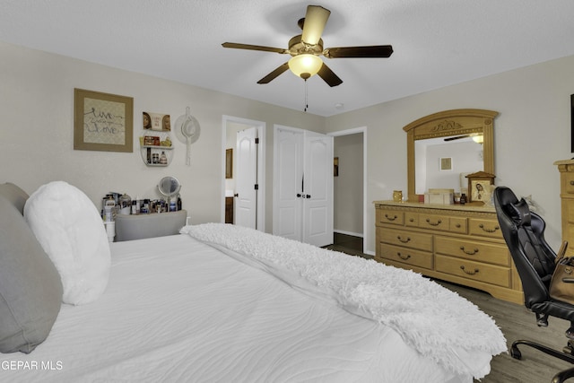 bedroom with wood-type flooring, a textured ceiling, and ceiling fan