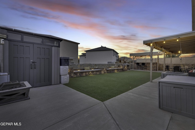 yard at dusk with a patio area