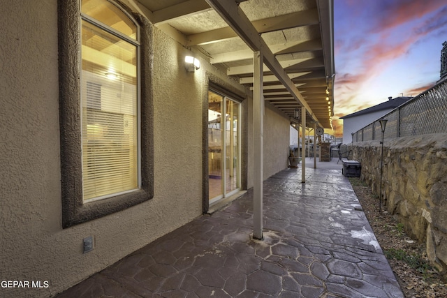 view of patio terrace at dusk