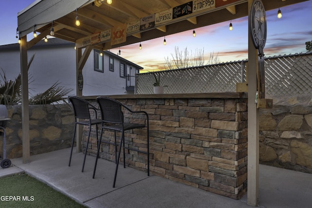 patio terrace at dusk with exterior bar