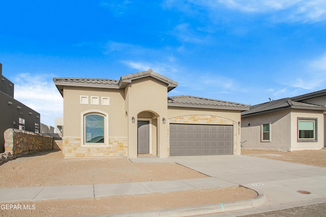 mediterranean / spanish-style home with a garage