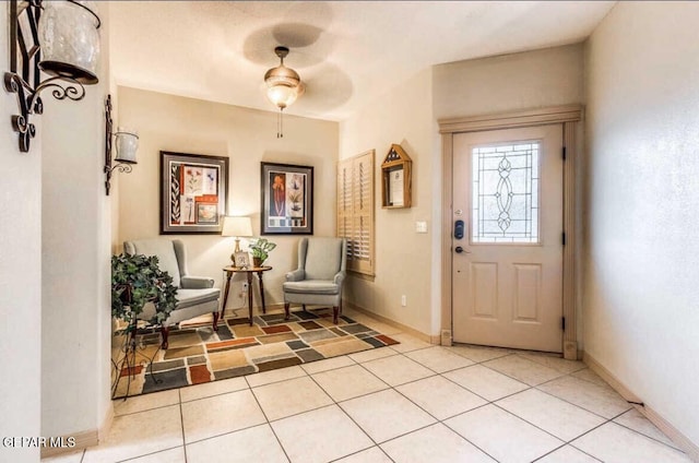 entryway featuring ceiling fan and light tile patterned floors