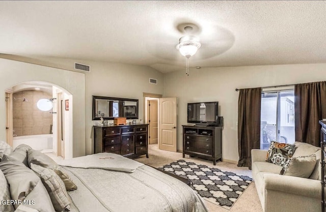 bedroom with vaulted ceiling, ceiling fan, a textured ceiling, and light carpet