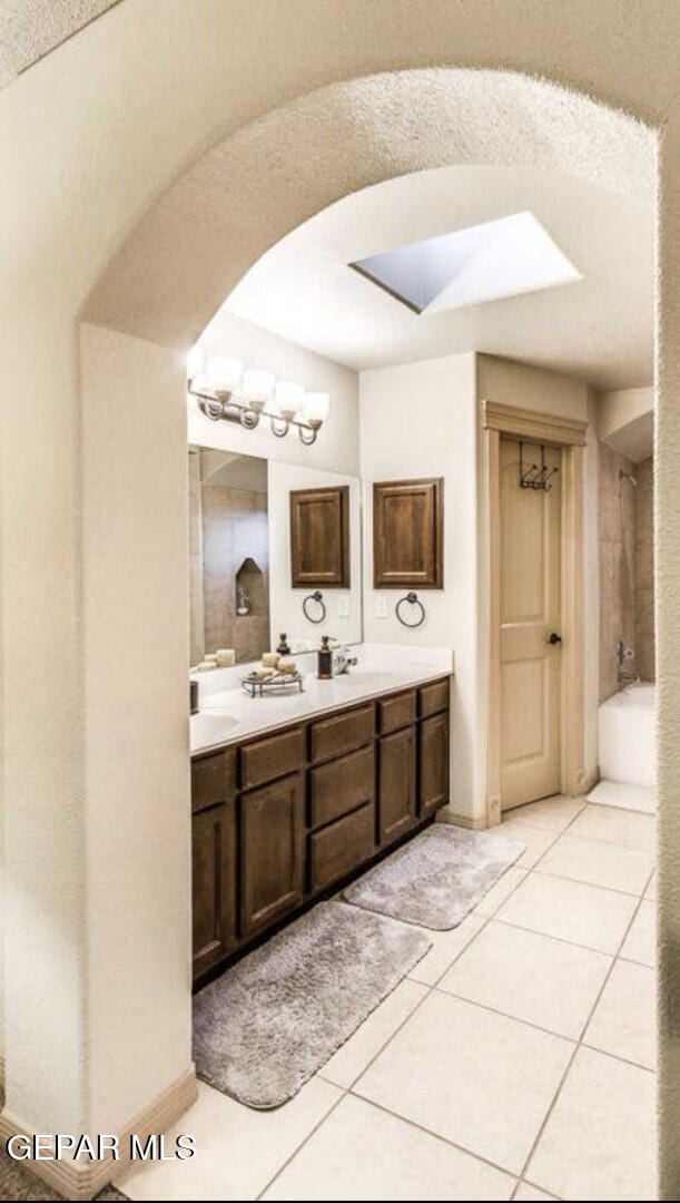 bathroom with tile patterned floors and vanity