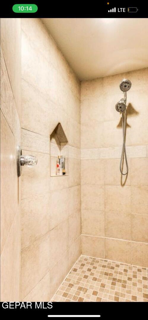 bathroom with a tile shower