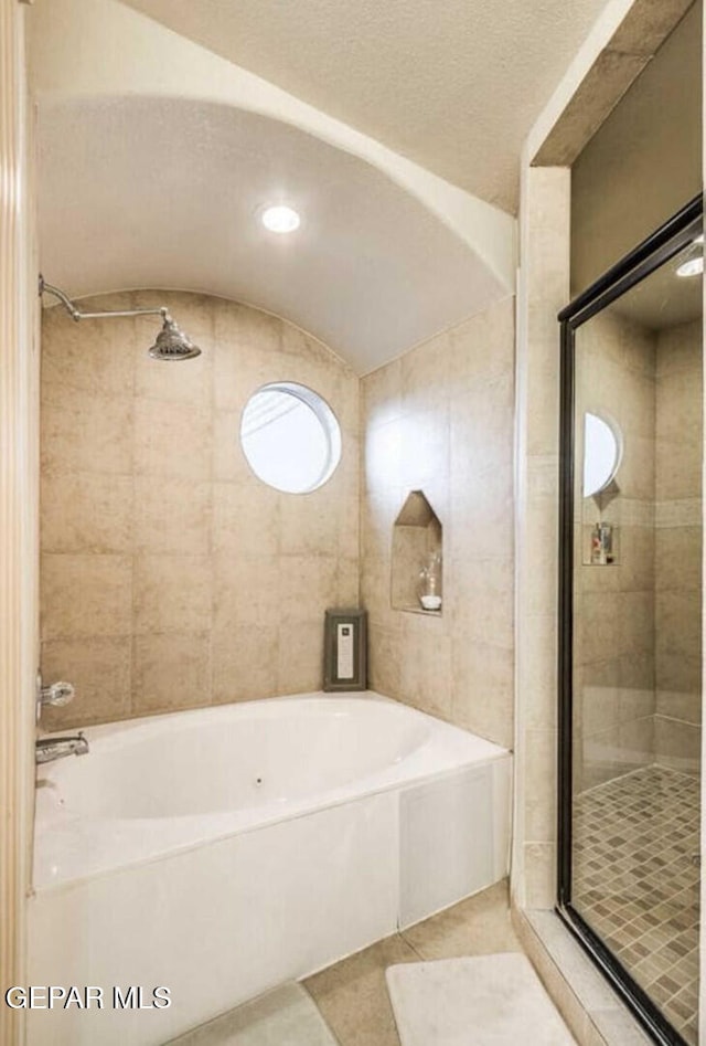 bathroom featuring tile patterned flooring and separate shower and tub