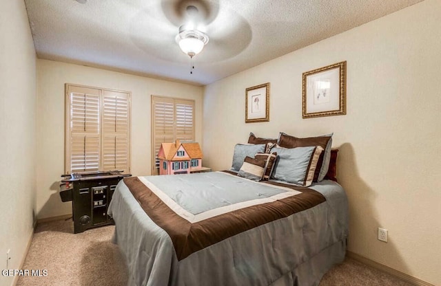 carpeted bedroom with ceiling fan and a textured ceiling